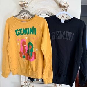 Anthropologie Midnight Rider Gemini Pullover and a black Gemini pullover size M